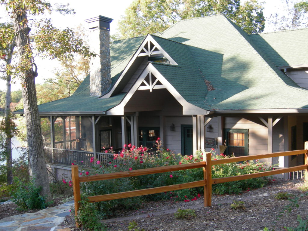 Remodeled cabin front entry with wooden post fence