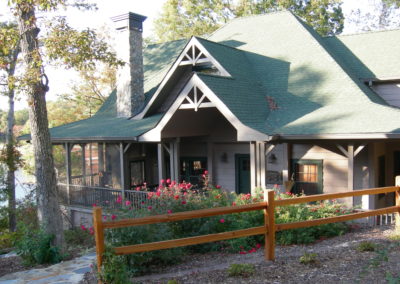 Remodeled cabin front entry with wooden post fence