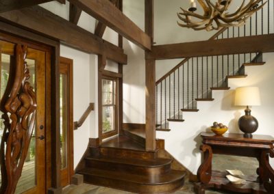 View of contemporary Lodge entry and front door with decorative wooden trim