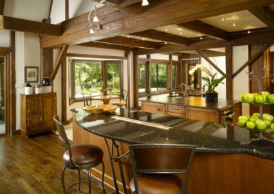 Contemporary lodge kitchen with wooden beams and black granite countertops