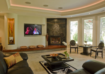 Gas log fireplace with granite face and walnut hearth in contemporary style living room