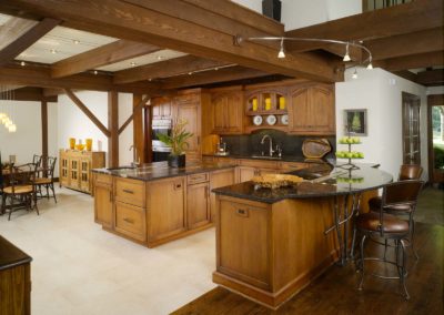 View of contemporary Lodge kitchen with white linoleum floors and black granite countertops on wooden counters