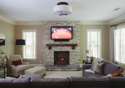 Fireplace with stone tile face in terrace level sitting room