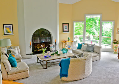 Black marble fireplace on white accent face and black marble hearth in expansive living room