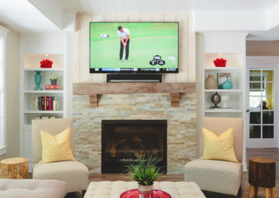 Terrace level living room with wood-burning fireplace on a stone tile face